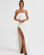 Solenne Maxi Dress featuring a bandeau design, high waist, and dramatic side slit for a modern, elegant look.