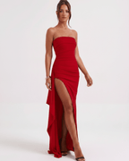 Solenne Maxi Dress featuring a red bandeau design, high waist, dramatic side slit and flowing asymmetric panel from Lauven brand.