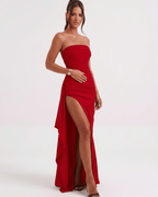 Solenne Maxi Dress in red, featuring a bandeau design, high waist, and dramatic side slit by Lauven.