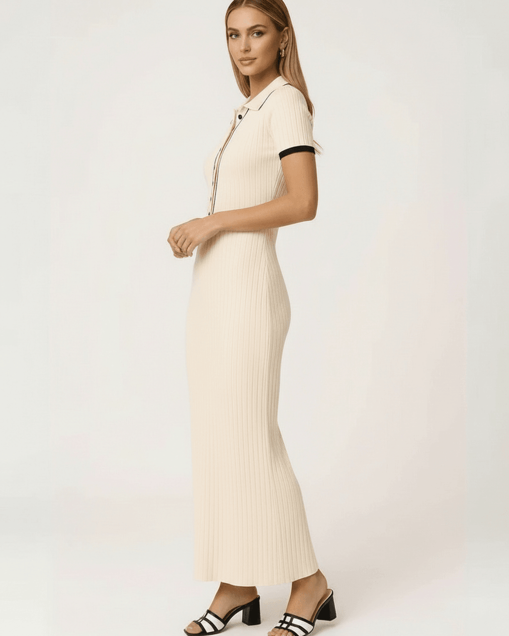 Side view of a woman wearing the Lauven Sorrento Maxi Dress in beige ribbed knit with collared button detail.