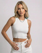Sorrento Top by Lauven - White ribbed knit cropped sleeveless women's top styled with high-waisted pants.