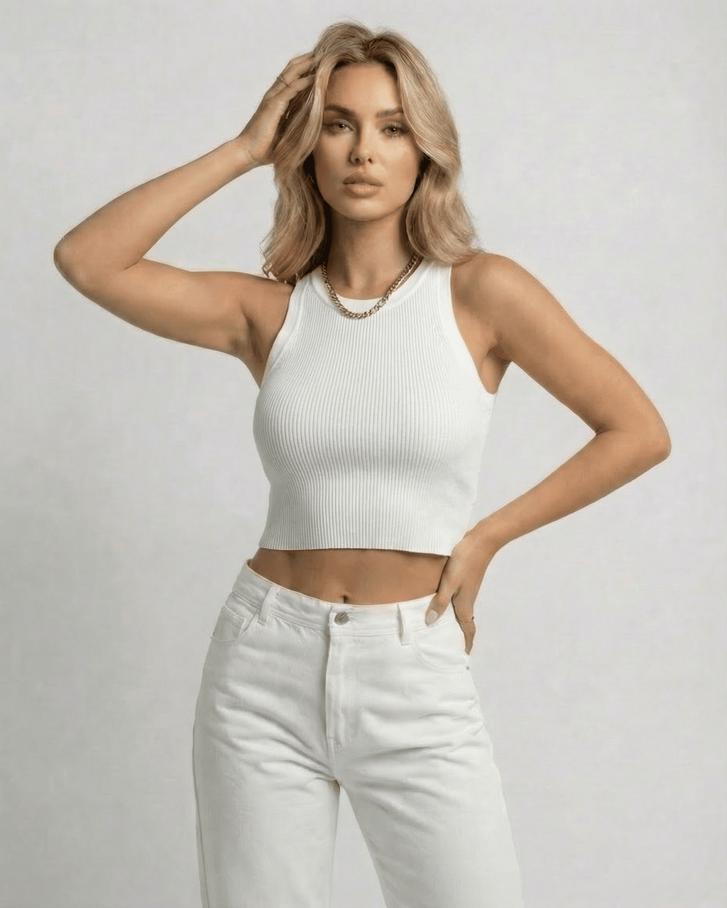 Model wearing Sorrento Top, a ribbed knit cropped sleeveless women’s white top by Lauven.
