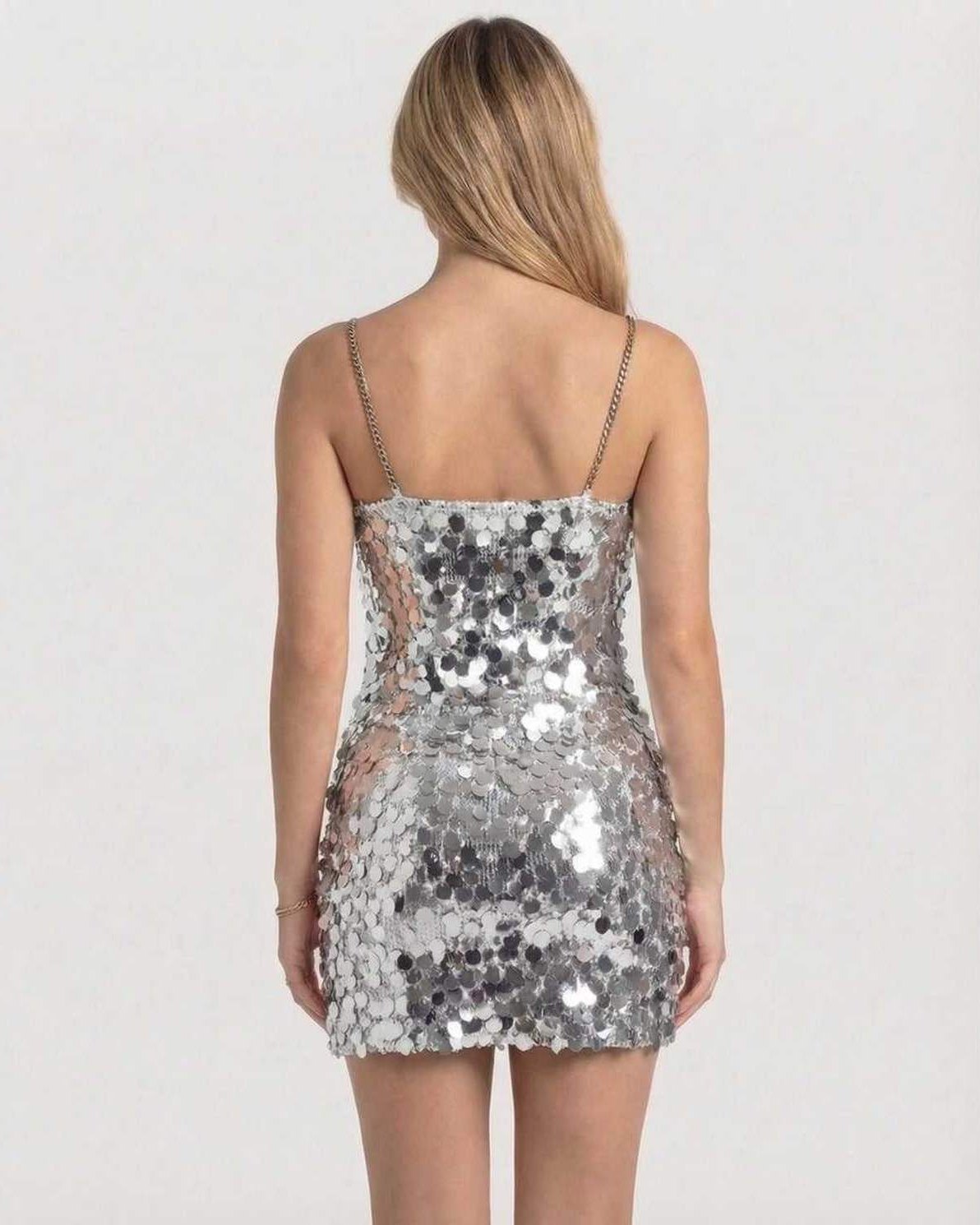 Sterling Mini Dress back view, silver sequin bodycon style by Lauven, showcasing chain straps and light-catching design.