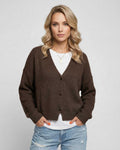 Model wearing the Terra Cardigan by Lauven, an elegant knitwear piece in rich brown for everyday sophistication.