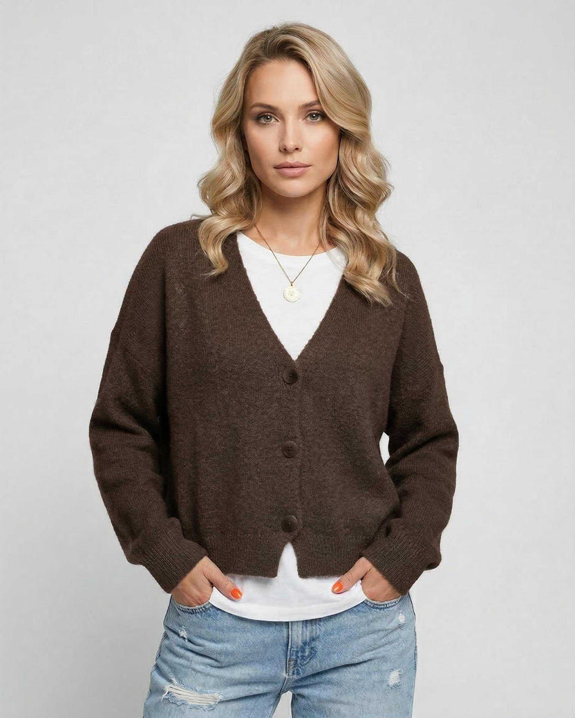 Model wearing the Terra Cardigan by Lauven, an elegant knitwear piece in rich brown for everyday sophistication.