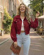 Valencia Jacket by Lauven: Women's red cropped jacket with lantern sleeves, stylishly worn outdoors.