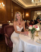 Valencia Maxi Dress by Lauven, elegant strapless white mermaid dress in a fine dining setting.