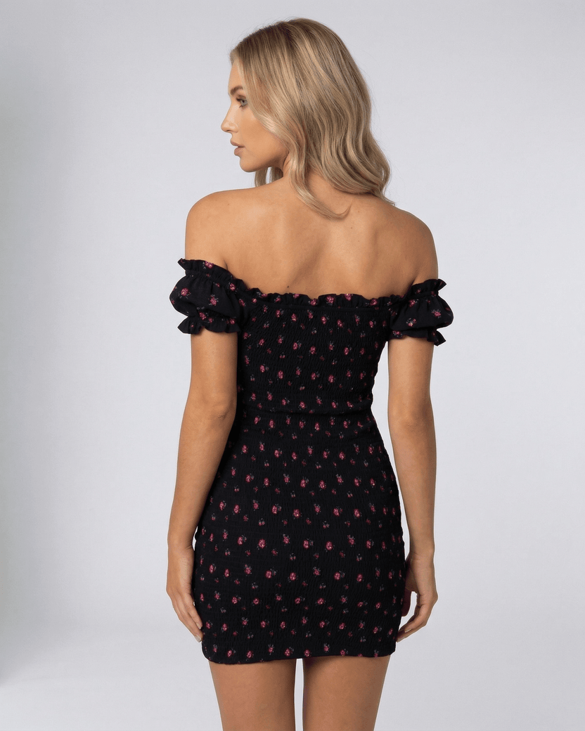 Valencia Mini Dress by Lauven, back view showcasing black floral off shoulder design and fitted silhouette.