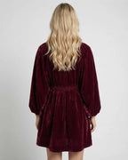 Valencia Mini Dress in burgundy velvet, showcasing long sleeve V neck silhouette from Lauven, perfect for elegant occasions.
