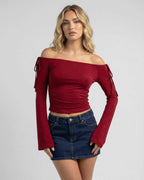 Lauven Valencia Top – Off-the-shoulder long sleeve slim fit top in deep burgundy worn with denim skirt.