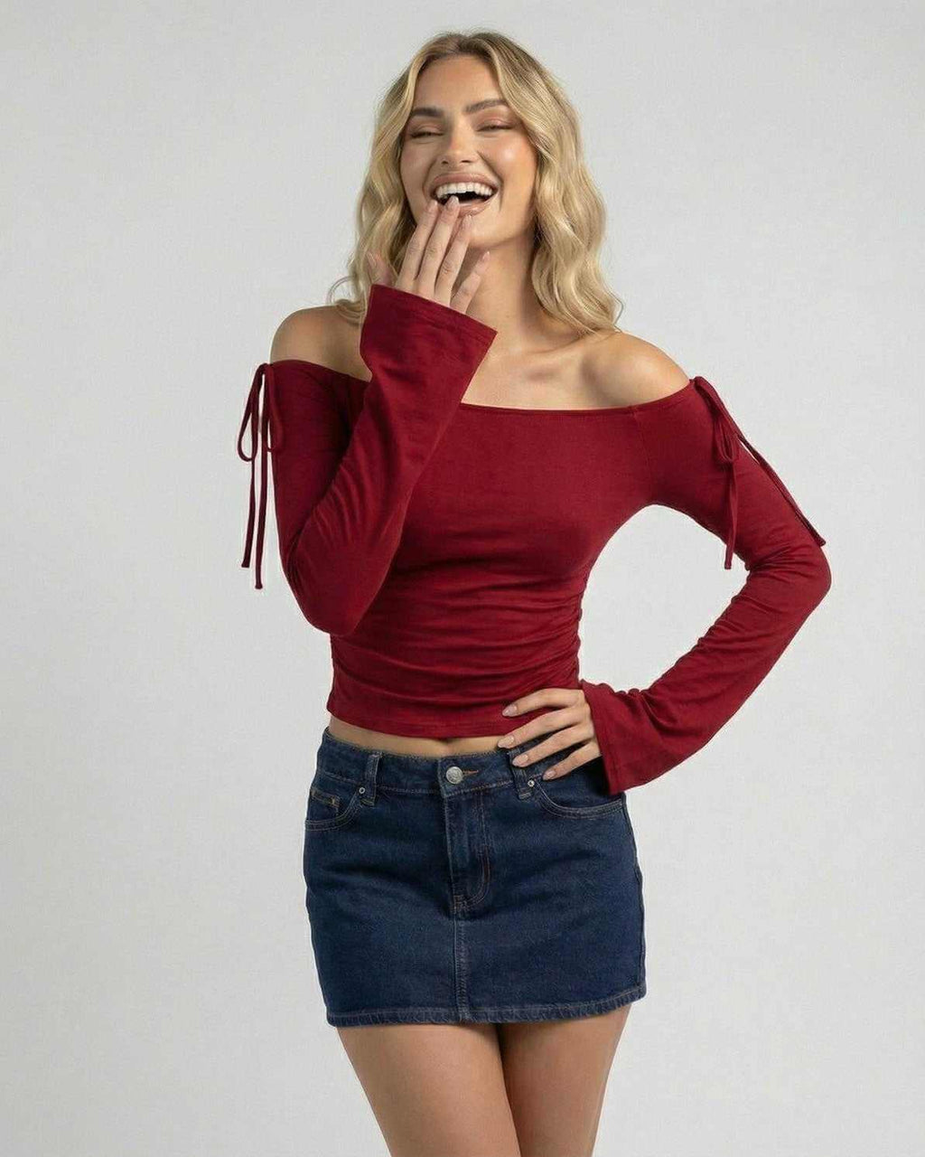 Woman wearing the Valencia Top by Lauven, an off-the-shoulder burgundy slim fit top with stylish sleeves.