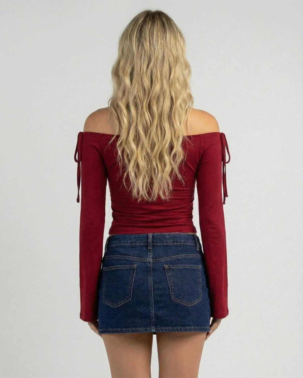 Back view of a woman wearing the Valencia Top by Lauven, an off-the-shoulder slim fit top in deep burgundy.