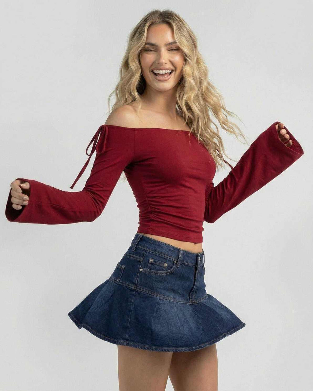 Valencia Top by Lauven, women's off-the-shoulder burgundy slim fit long sleeve top styled with denim skirt.