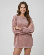 Women wearing the Verona Sweater by Lauven, showcasing its ribbed oversized design in a soft dusty rose tone.