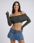 Woman wearing the Verona Top, an off shoulder long sleeve crop top, styled with a denim skirt from Lauven brand.