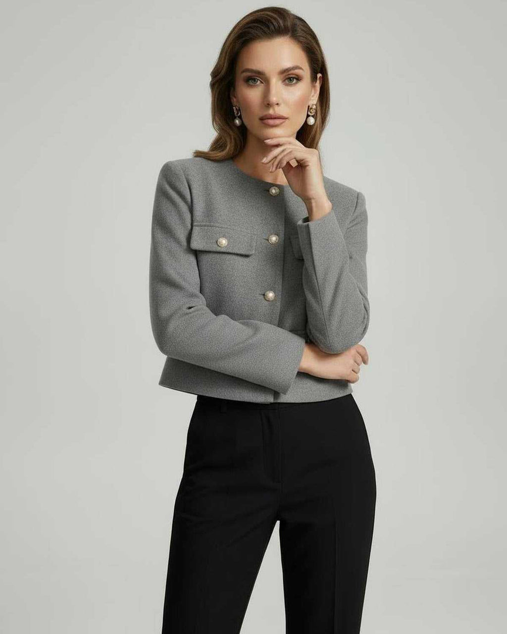 Vesper Jacket by Lauven worn by model, featuring a tailored grey wool blend design with gold button accents.