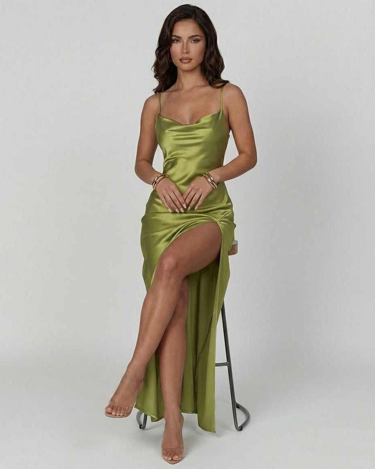 Vesper Maxi Dress by Lauven, a sleek olive green satin dress with an asymmetrical silhouette highlighting the figure.