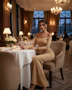 Lauven Vesper Maxi Dress in neutral beige, elegant off-shoulder silhouette, ideal for luxury dining.