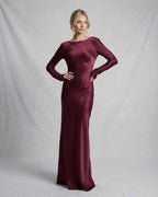 Vesper Maxi Dress by Lauven in rich burgundy satin, featuring a sleek silhouette and elegant long sleeves.