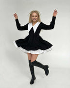 Model showcasing the Vesper Mini Dress by Lauven, featuring chic black and white patchwork and a lapel collar.