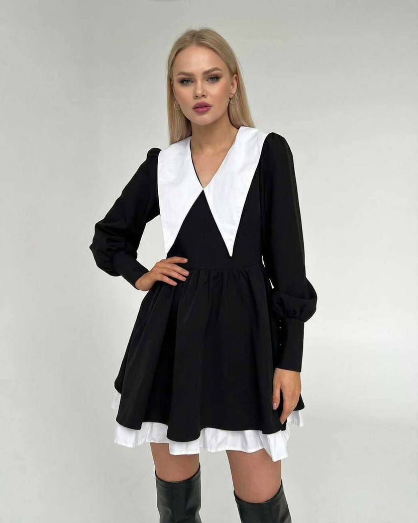Vesper Mini Dress by Lauven featuring chic black and white patchwork, lapel collar, and flowing skirt.