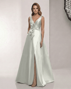 Virelle Maxi Dress in sage silver satin, featuring a V-neck, bow detail, and A-line silhouette by Lauven.