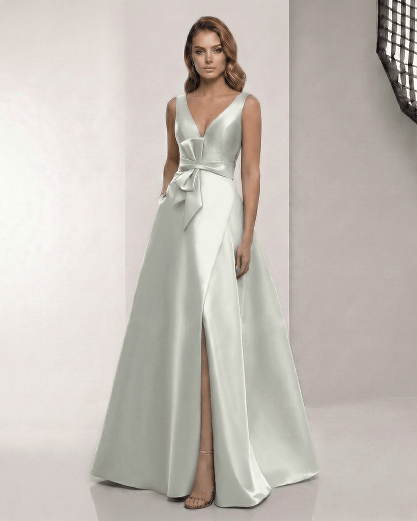 Virelle Maxi Dress in sage silver satin, featuring a V-neck, bow detail, and A-line silhouette by Lauven.