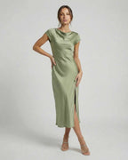 Virgo Midi Dress in soft sage green, sleek satin fabric, modern cowl neck, featuring twisted-back and chic cutout detail by Lauven.