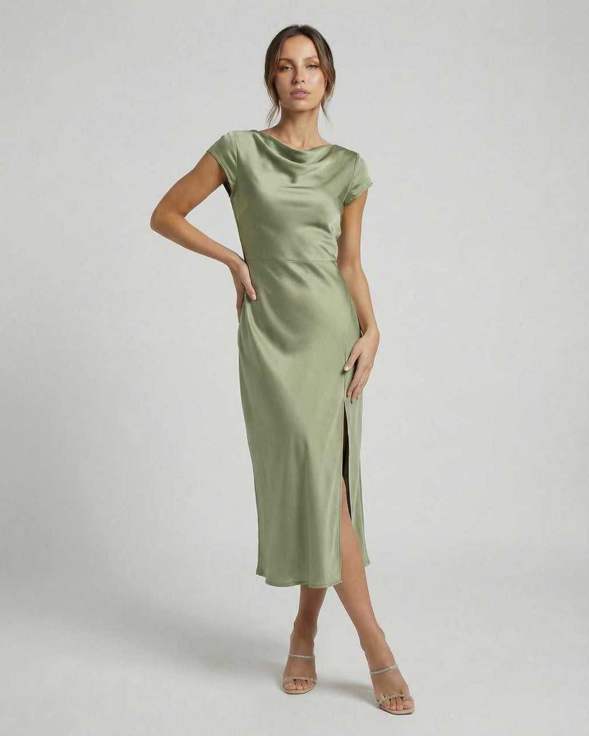 Virgo Midi Dress in soft sage green, sleek satin fabric, modern cowl neck, featuring twisted-back and chic cutout detail by Lauven.