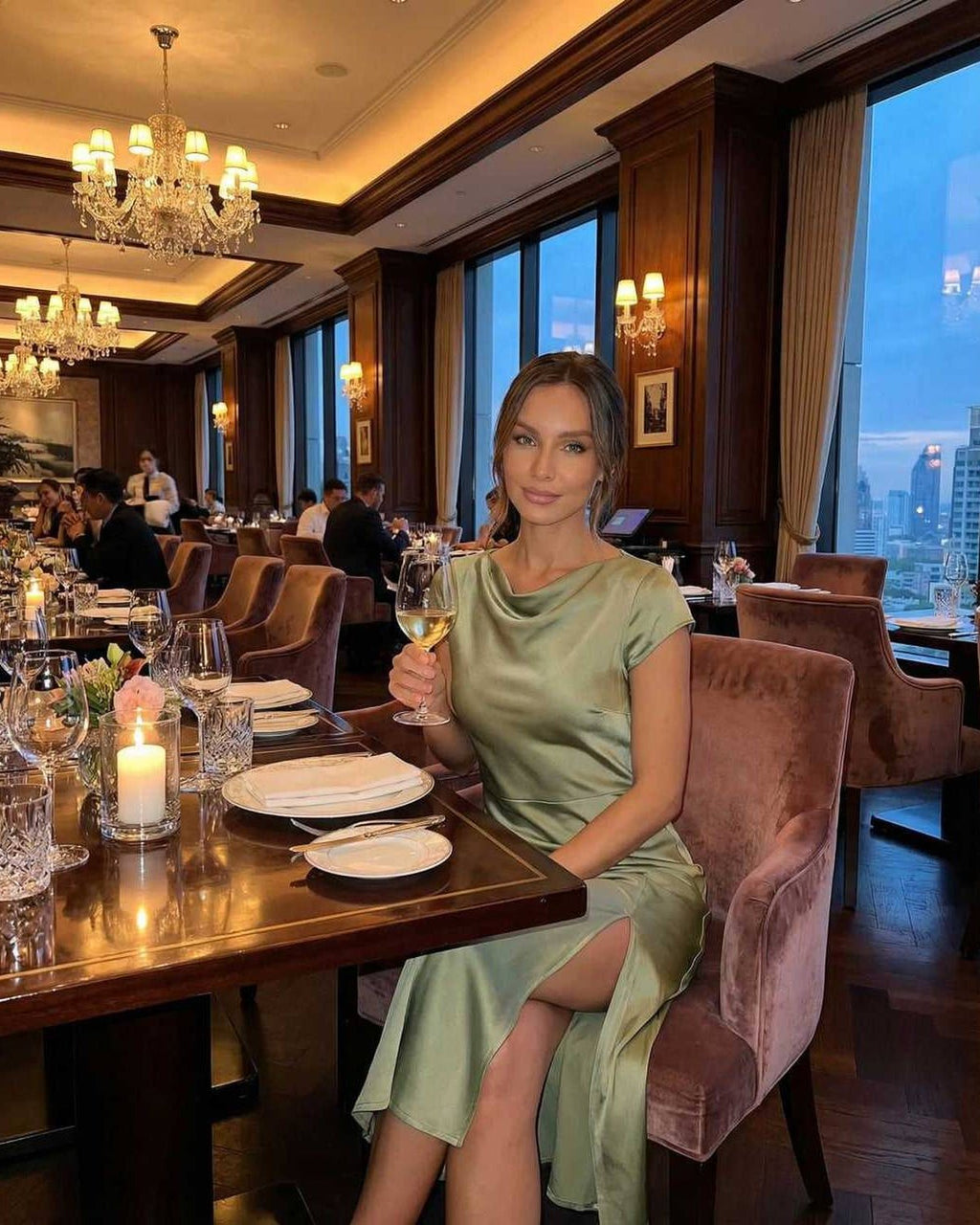 Virgo Midi Dress by Lauven in soft sage green, featuring satin fabric, twisted-back, and a sophisticated look at a classy dinner.