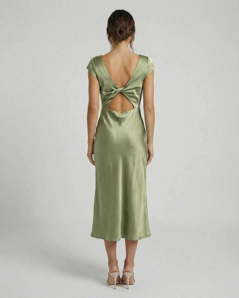 Virgo Midi Dress featuring a twisted-back and cutout detail in soft sage green, by Lauven. Elegant satin design.