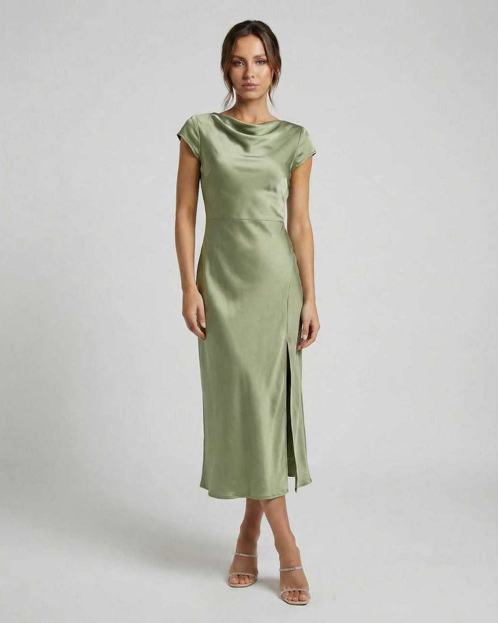 Virgo Midi Dress showcasing a sleek satin material, twisted back, and cutout detail in soft sage green by Lauven.