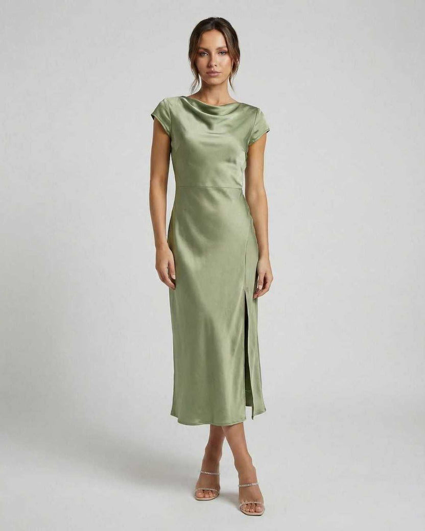 Virgo Midi Dress showcasing a sleek satin material, twisted back, and cutout detail in soft sage green by Lauven.
