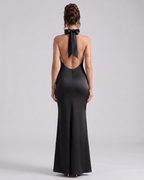Zerelle Maxi Dress in black, featuring a smooth polyester fabric, halter neckline, and elegant ruffle details by Lauven.